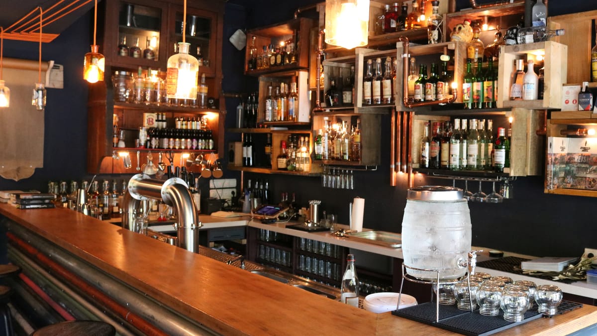 A modern cocktail bar — illustrative of the venue type a Deluxe drink package targets.